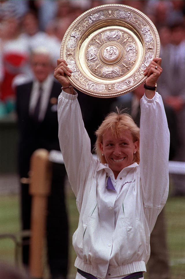 Martina Navratilova holds the singles trophy for a record ninth time 