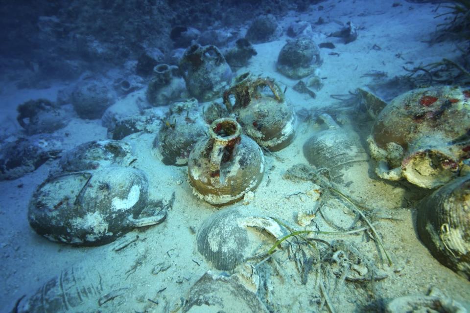 This undated handout photo provided by the Greek Culture Ministry on Monday, Oct. 15 , 2018, showing items on the seabed from an ancient shipwreck discovered off the island of Fourni. Greece's culture ministry says a Greek-U.S. team has located traces of five more ancient shipwrecks in the eastern Aegean Sea, raising to 58 the number of wrecks located since 2015 around Fourni, a notoriously dangerous point on the ancient shipping route. (Greek Culture Ministry via AP)