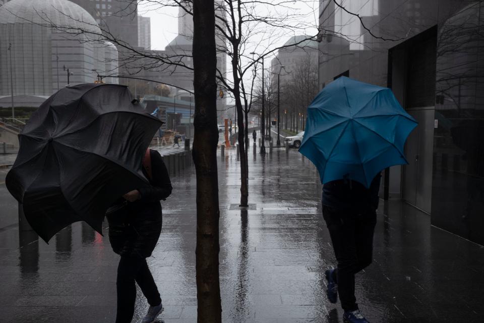 Pedestrians push their umbrellas against the wind as rain falls in downtown Manhattan in New York on Wednesday, April 3, 2024. More severe weather is coming across the nation. A major spring storm is expected to drop more than a foot of snow in parts of New England on Wednesday, while heavy rains are likely to soak the East Coast. (AP Photo/Patrick Sison)