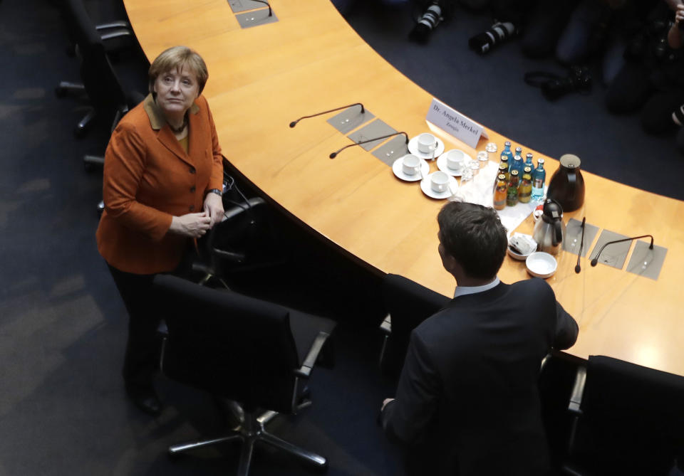 German Chancellor Angela Merkel, left, arrives for a questioning at an investigation committee of the German federal parliament looking into alleged U.S. surveillance in Germany and the activities of Germany's own foreign intelligence service in Berlin, Germany, Thursday, Feb. 16, 2017. (AP Photo/Markus Schreiber)