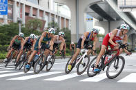 <p>Canada's Matthew Sharpe rides ahead of France's Dorian Coninx, Australia's Aaron Royle, Germany's Justus Nieschlag and other competitors during the men's individual triathlon competition at the Odaiba Marine Park, in Tokyo, on July 26, 2021 during the Tokyo 2020 Olympic Games. (Photo by Cameron Spencer / POOL / AFP) (Photo by CAMERON SPENCER/POOL/AFP via Getty Images)</p> 