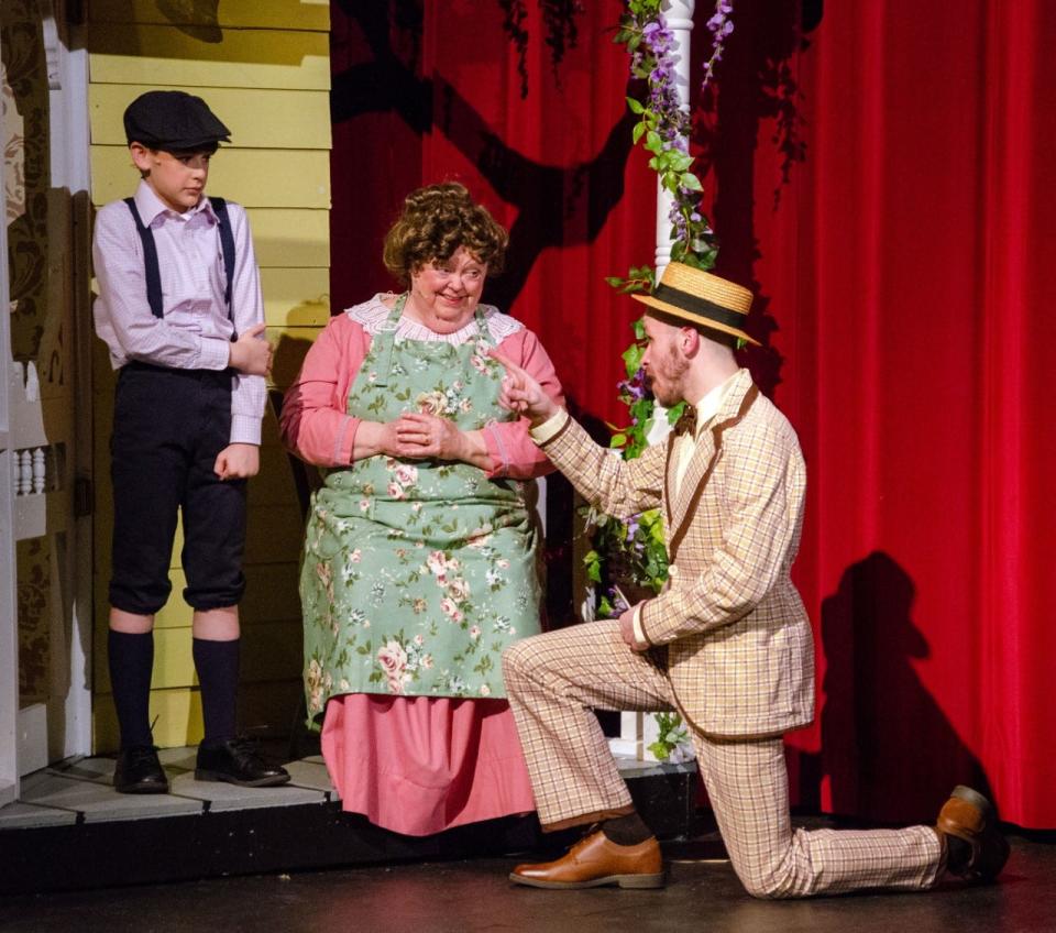 Harold (Randy Rininger Kline) convinces Mrs. Paroo (Joan M. Conlon) to buy a musical instrument for Winthrop (Dominic Falconer) during a rehearsal of "The Music Man" at Firehouse Theater in Alliance. Carnation City Players is presenting the classic musical beginning this weekend.