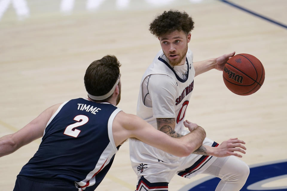 Saint Mary's guard Logan Johnson, right, is defended by Gonzaga forward Drew Timme (2) during the second half of an NCAA college basketball game in Moraga, Calif., Saturday, Jan. 16, 2021. (AP Photo/Jeff Chiu)