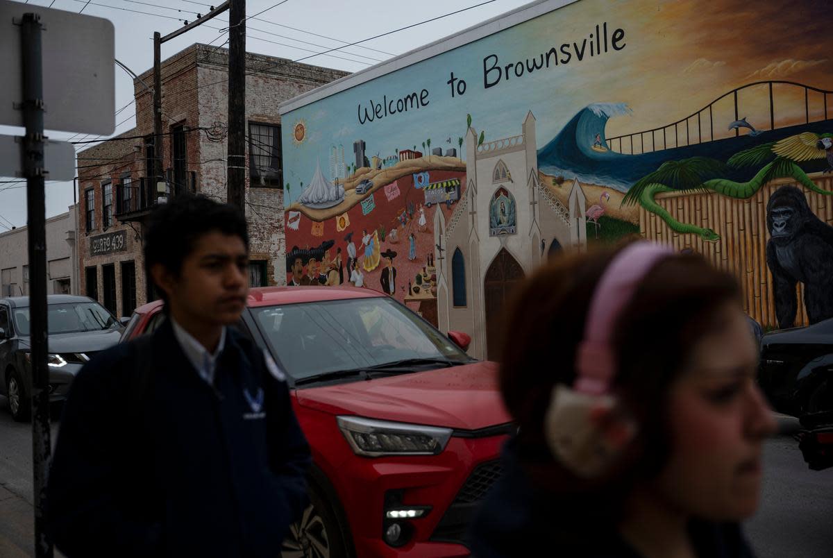 Pedestrians walk through downtown Brownsville early Thursday, Feb. 29, 2024. President Joe Biden visited Brownsville on Thursday, receiving briefings from U.S. Customs and Border Patrol, USCIS, and ICE along the border before giving remarks at the Brownsville Border Patrol Station.