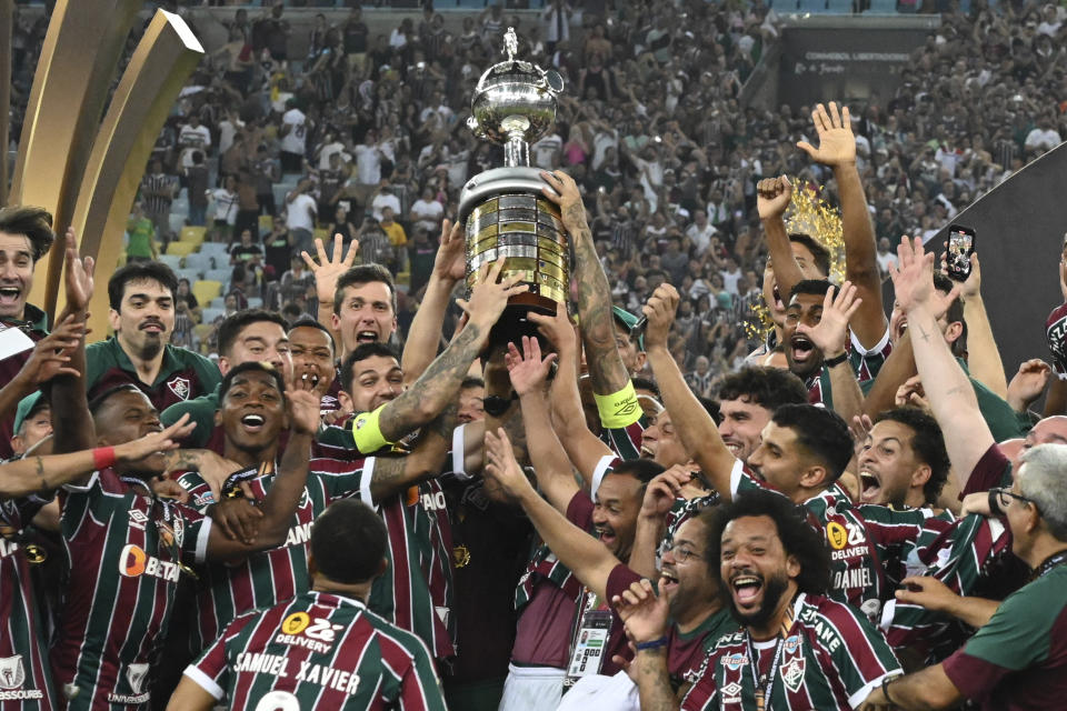 Players of Brazil's Fluminense celebrate with the trophy after winning the Copa Libertadores final soccer match against Argentina's Boca Juniors at Maracana stadium in Rio de Janeiro, Brazil, Saturday, Nov. 4, 2023. (AP Photo/Alexandre Brum)