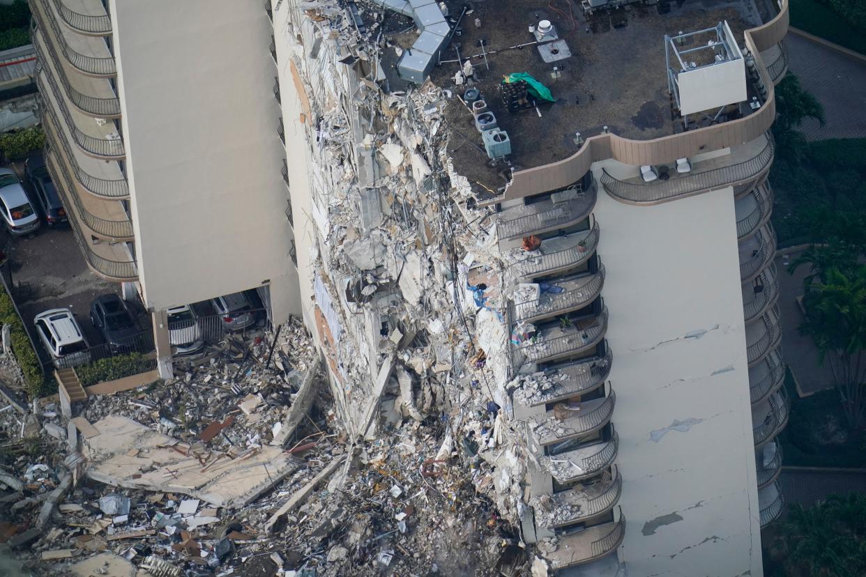 Rescue workers search in the rubble at the Champlain Towers South Condo, Saturday, June 26, 2021, in Surfside, Fla. The apartment building collapsed on Thursday.