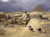 1938 | EGYPT: Three figures on camelback behold the pyramids of Giza. (Photo by B. Anthony Stewart) <br> <br> <a href="http://www.nationalgeographic.com/125/" rel="nofollow noopener" target="_blank" data-ylk="slk:Click here for more info at NationalGeographic.com;elm:context_link;itc:0;sec:content-canvas" class="link ">Click here for more info at NationalGeographic.com</a>