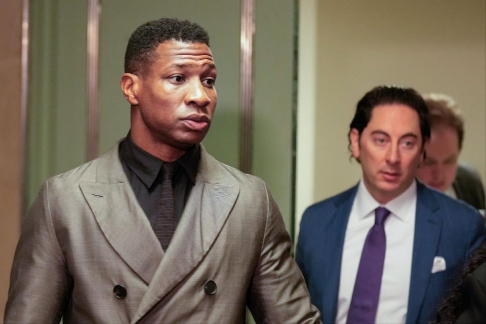 Jonathan Majors, left, enters a courtroom at the Manhattan criminal courts in New York on Monday (AP)