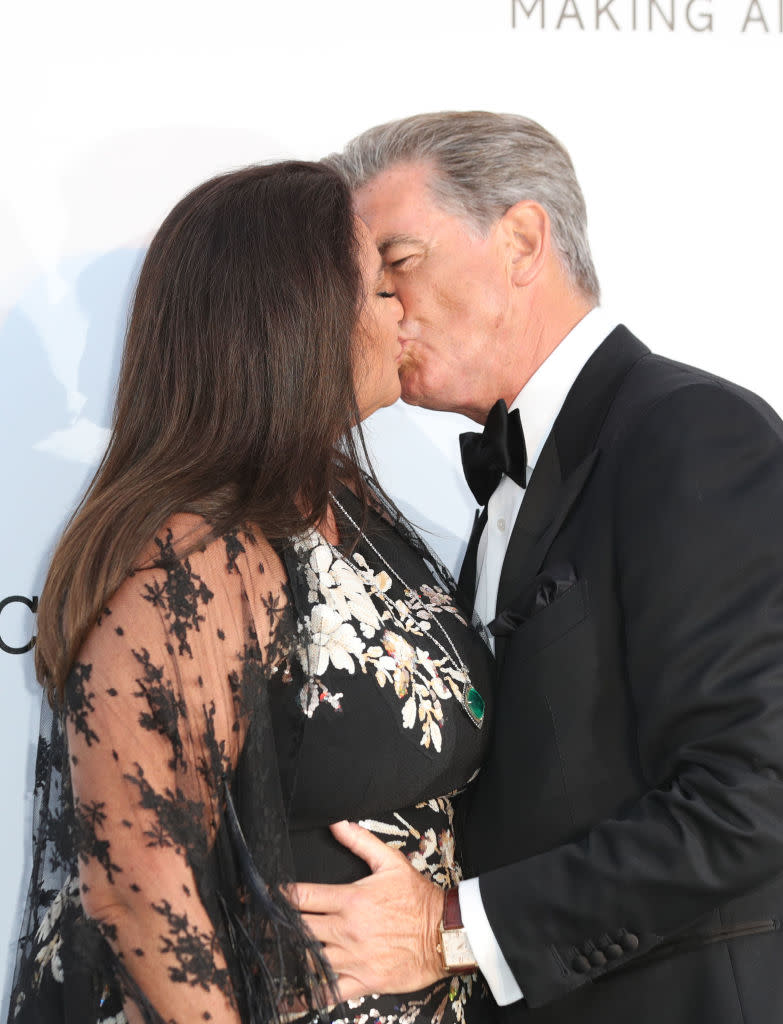 Pierce Brosnan and his wife share a tender kiss, pictured in May 2018 in Cannes. (Getty Images)
