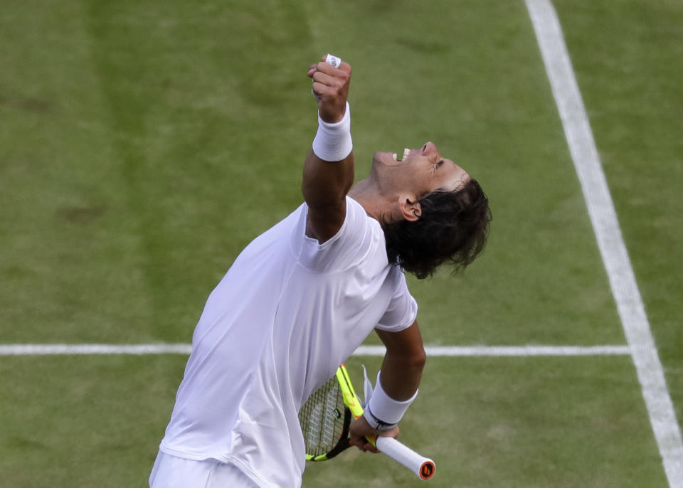 Spain's Rafael Nadal celebrates winning a men's quarterfinal match against United States' Sam Querrey on day nine of the Wimbledon Tennis Championships in London, Wednesday, July 10, 2019. (AP Photo/Kirsty Wigglesworth)