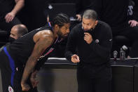 Los Angeles Clippers head coach Tyronn Lue, right, talks with guard Paul George during the first half in Game 4 of a second-round NBA basketball playoff series against the Utah Jazz Monday, June 14, 2021, in Los Angeles. (AP Photo/Mark J. Terrill)