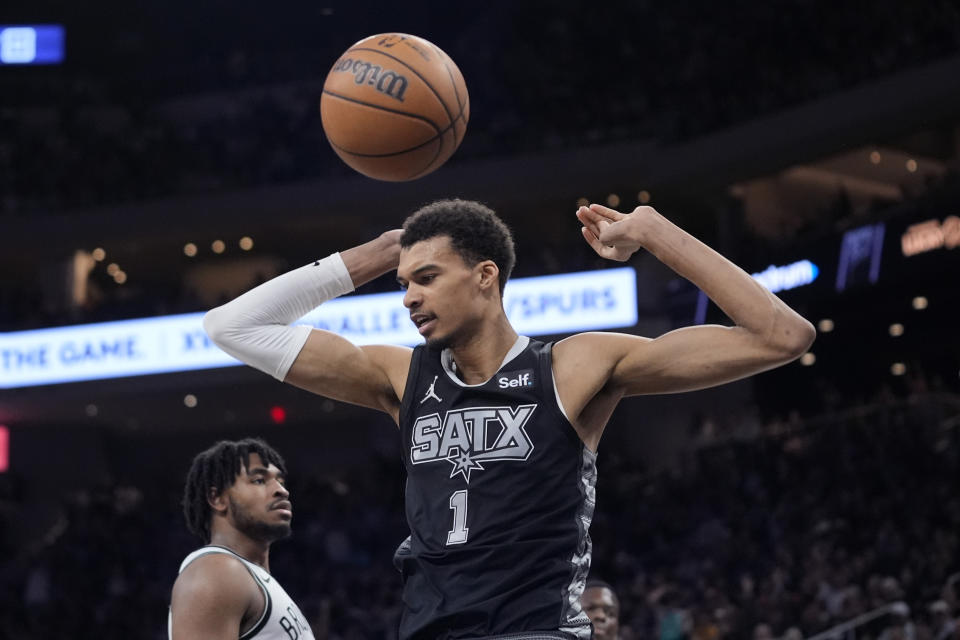 San Antonio Spurs center Victor Wembanyama (1) scores against the Brooklyn Nets during the second half of an NBA basketball game in Austin, Texas, Sunday, March 17, 2024. (AP Photo/Eric Gay)