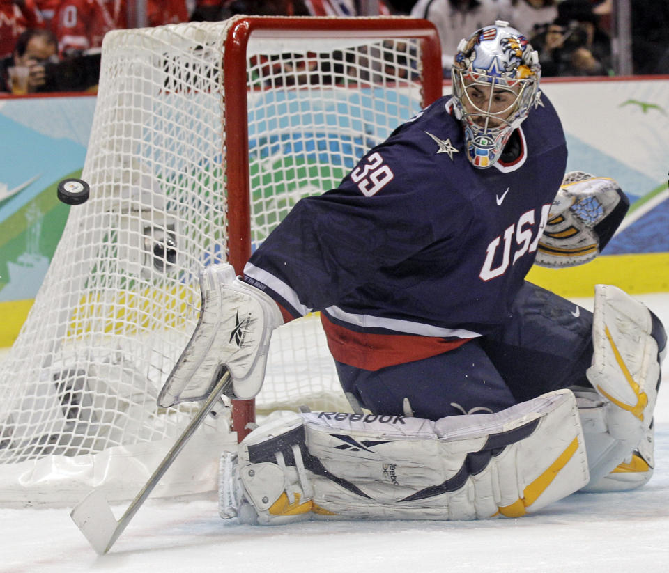 FILE - USA goalie Ryan Miller (39) makes a save in the first period of the men's gold medal ice hockey game against Canada at the Vancouver 2010 Olympics in Vancouver, British Columbia, Sunday, Feb. 28, 2010. Longtime NHL goaltender Ryan Miller and Olympic gold medal-winning women’s hockey stars Jocelyne Lamoureux-Davidson and Monique Lamoureux-Morando headline the 2022 class of the U.S. Hockey Hall of Fame unveiled Thursday, Sept. 8, 2022. (AP Photo/Matt Slocum, File)