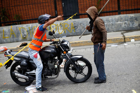 A demonstrator blocks a street during a strike called to protest against Venezuelan President Nicolas Maduro's government in Caracas, Venezuela July 27, 2017 . REUTERS/Andres Martinez Casares