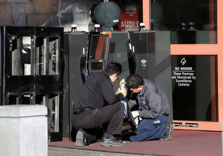 Workers repair slot machines outside of the River Rock Casino in Richmond, British Columbia, Canada December 5, 2017. REUTERS/Ben Nelms