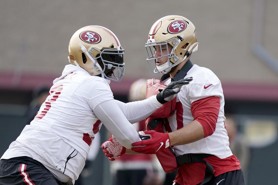San Francisco 49ers defensive tackle Earl Mitchell, left, and defensive end Nick Bosa, right, go through drills during NFL football practice at the team's training facility in Santa Clara, Calif., Wednesday, Jan. 15, 2020. The 49ers will host the Green Bay Packers for the NFC Championship on Sunday. (AP Photo/Tony Avelar)