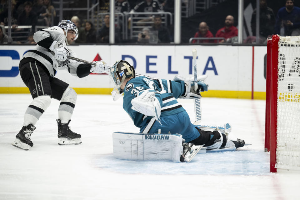 Los Angeles Kings left wing Kevin Fiala (22) scores past San Jose Sharks goaltender Kaapo Kahkonen (36) during the second period of an NHL hockey game Wednesday, Dec. 27, 2023, in Los Angeles. (AP Photo/Kyusung Gong)