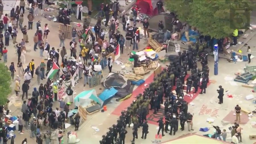 Law enforcement officers are seen dismantling a pro-Palestinian protest encampment at UC Irvine on May 15, 2024. (KTLA)