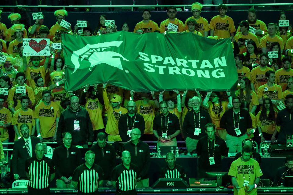 Michigan fans hold a “Spartan Strong” Flag in the Maize Rage student section to show their support for the Michigan State community before the first half against Michigan State at Crisler Center in Ann Arbor on Saturday, Feb. 18, 2023.