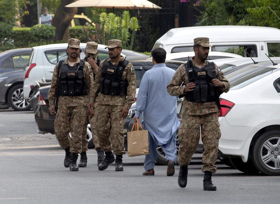 Pakistani soldiers patrol in a parking lot of the hotel where British royal couple stays, in Islamabad, Pakistan, Tuesday, Oct. 15, 2019. Britain's Prince William and his wife Kate kicked off a five-day tour of Pakistan on Tuesday, amid much fanfare and tight security. Authorities deployed more than 1,000 police and paramilitary forces to ensure the royal entourage's protection. (AP Photo/B.K. Bangash)