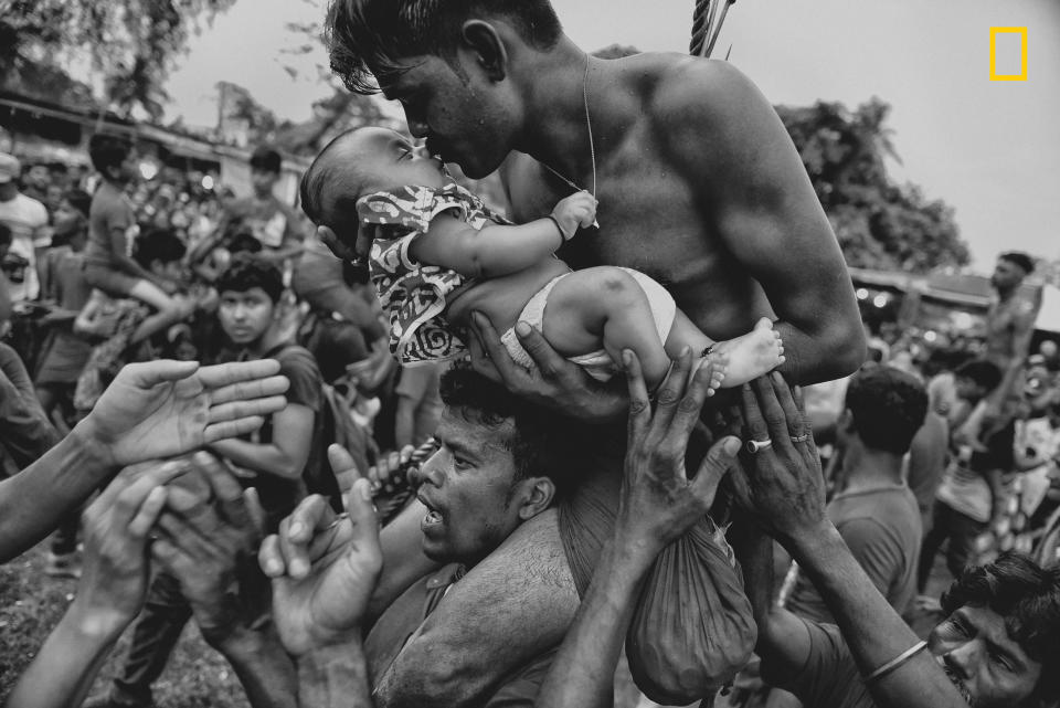 A Hindu devotee kisses his newborn baby during the Charak Puja festival in West Bengal, India. Traditional practice calls for the devotee to be pierced with a hook and sometimes swung from a rope. This painful sacrifice is enacted to save their children from anxiety. While covering the festival, I was able to view the religious practice from the perspective of Hindu devotees. I tried to capture the moment of love and bonding between a father and his child -- and show a father&rsquo;s concern for his little son.