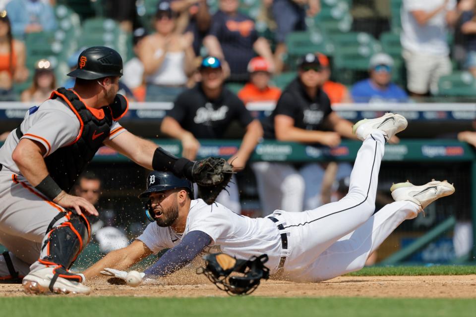 Detroit Tigers center fielder Riley Greene (31) dives in to score against the San Francisco Giants in the eighth inning at Comerica Park in Detroit on Saturday, April 15, 2023.