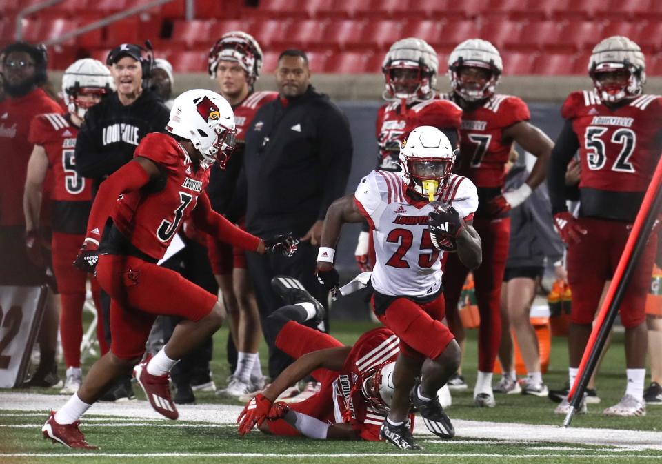 Louisville’s Isaac Brown runs against Louisville’s defense during the spring game in April.