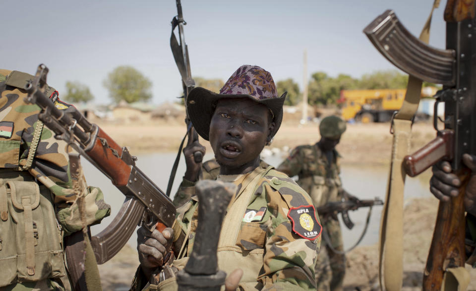 FILE - In this Sunday Jan. 12, 2014 file photo, a South Sudanese government soldier chants in celebration after government forces on Friday retook from rebel forces the provincial capital of Bentiu, in Unity State, South Sudan. A new report made public in Nov. 2019 says South Sudan's National Security Service has recruited a force of 10,000 fighters in President Salva Kiir's ethnic stronghold, in apparent breach of the terms of the country's peace deal. (AP Photo/Mackenzie Knowles-Coursin, File)