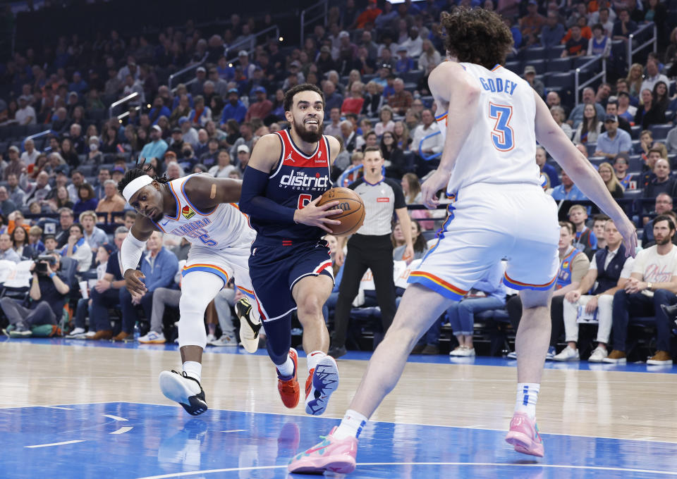 Feb 23, 2024; Oklahoma City, Oklahoma, USA; Washington Wizards guard Tyus Jones (5) drives to the basket as Oklahoma City Thunder guard Josh Giddey (3) defends during the first quarter at Paycom Center. Mandatory Credit: Alonzo Adams-USA TODAY Sports