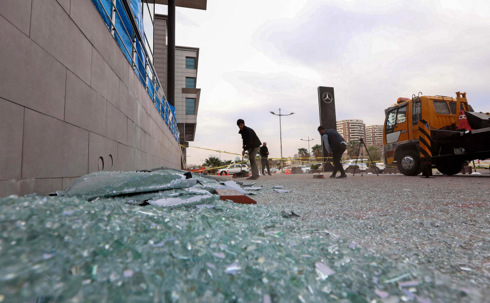 Image: A worker cleans shattered glass outside a damaged shop following a rocket attack the previous night in Irbil, the capital of the northern Iraqi Kurdish autonomous region (Safin Hamed / AFP - Getty Images file)
