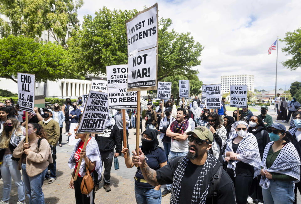 Pro-Palestinian supporters hold signs as they demonstrate at the University of California, Irvine in Irvine, Calif., on Thursday, April 25, 2024. The University of Southern California canceled its main graduation ceremony Thursday and hundreds of college students were arrested at other campuses nationwide as protests against the Israel-Hamas war continued to spread. (Paul Bersebach/The Orange County Register via AP)