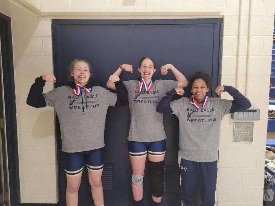 Bald Eagle Area’s (from the left) Grace Crestani, Angelina Grieb and Eden Eveleth celebrate winning their first district medals together at the District 5/6/9 Tournament on Saturday at the University of Pittsburgh-Johnstown.
