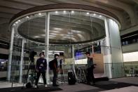 Members of the media are seen working at the empty Tokyo Stock Exchange (TSE) after the TSE temporarily suspended all trading due to system problems in Tokyo