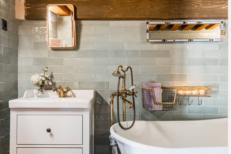 Bathroom with tile wall and clawfoot tub.