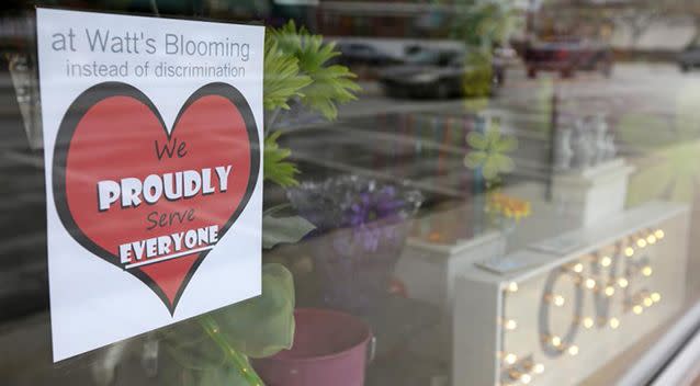 A window sign on a downtown Indianapolis florist shows its objection to the Religious Freedom bill passed by the Indiana legislature. Photo: AP/Michael Conroy