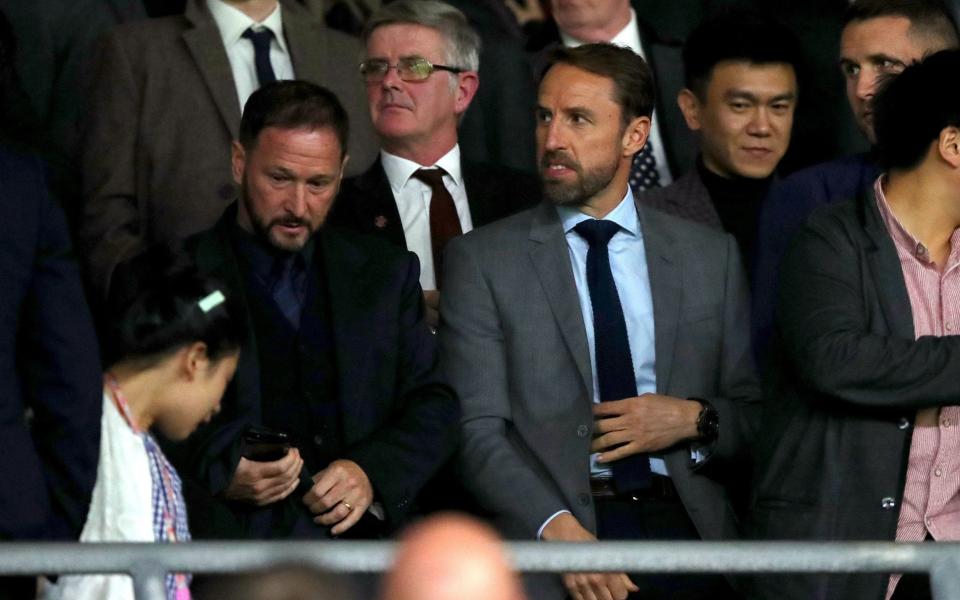 England Manager Gareth Southgate (right) in the stands earlier this season - PA