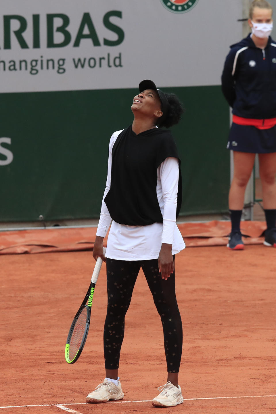 Venus Williams of the U.S. reacts after missing a shot against Slovakia's Anna Karolina Schmiedlova in the first round match of the French Open tennis tournament at the Roland Garros stadium in Paris, France, Sunday, Sept. 27, 2020. (AP Photo/Michel Euler)