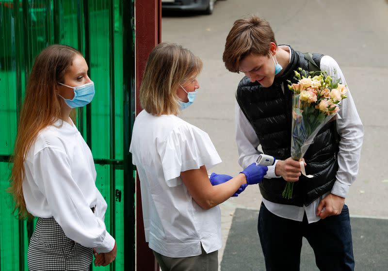 FILE PHOTO: A student has his temperature checked on the first day of the new school year in Moscow
