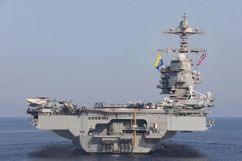 a side view of a military aircraft carrier