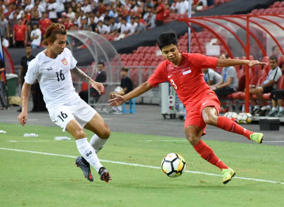 Singapore's Irwan Shah (right) and Myanmar's Si Thu Aung battle for possession during their international friendly at National Stadium. (PHOTO: Zainal Yahya/Yahoo News Singapore)