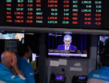 Traders look on as a screen shows Federal Reserve Chairman Jerome Powell's news conference after the U.S. Federal Reserve interest rates announcement on the floor of the New York Stock Exchange (NYSE) in New York