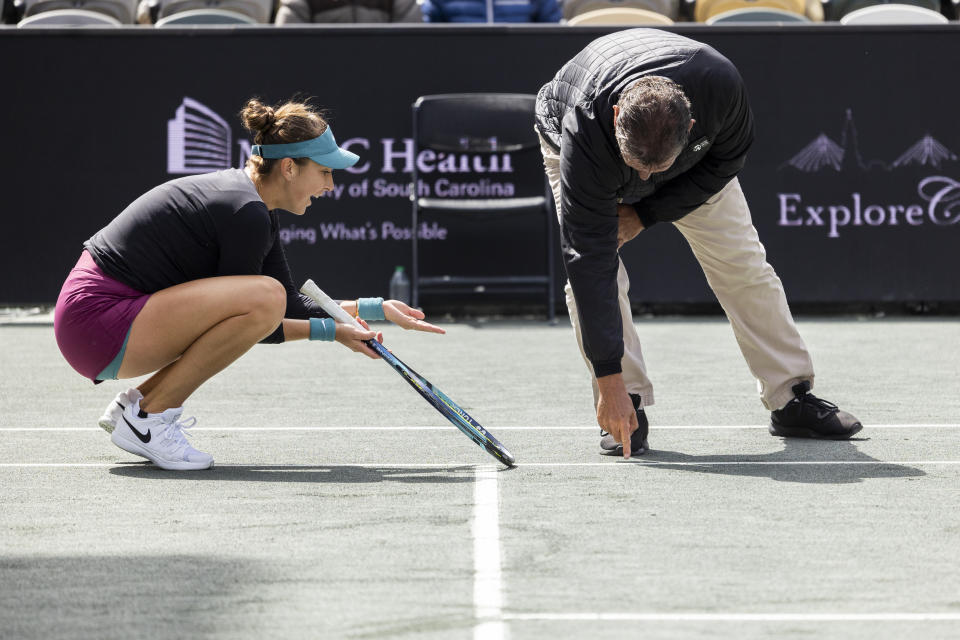 Belinda Bencic, of Switzerland, pleads with the chair umpire that a shot was out during her match against Ons Jabeur, of Tunisia, during the championship match at the Charleston Open tennis tournament in Charleston, S.C., Sunday, April 9, 2023. The ball was called in and Jabeur was given the first set. (AP Photo/Mic Smith)