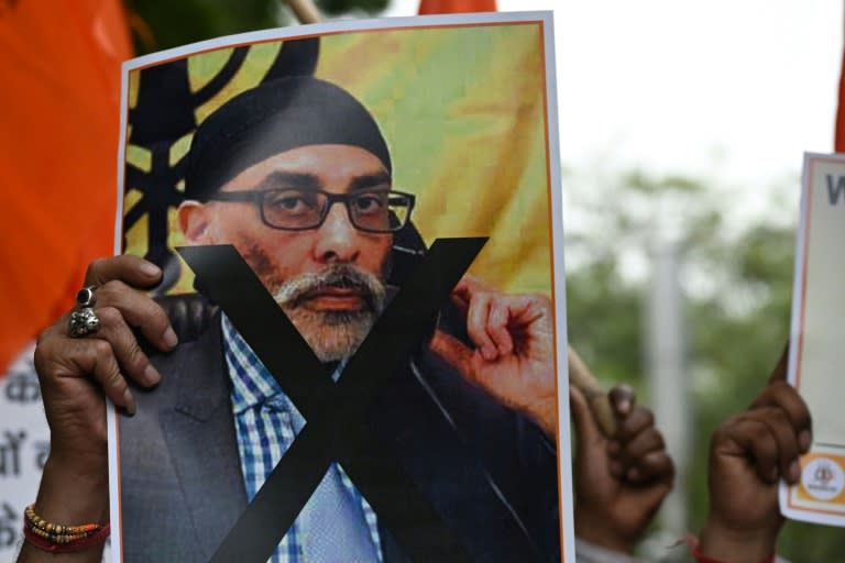 A member of United Hindu Front organization holds a picture of Gurpatwant Singh Pannun, the alleged target of an assassination plot (Arun SANKAR)