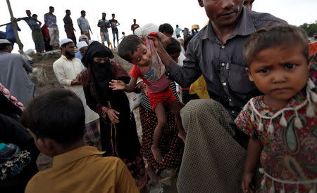 Newly arrived Rohingya refugees board a boat as they transfer to a camp in Cox's Bazar, Bangladesh, October 2, 2017. REUTERS/Cathal McNaughton