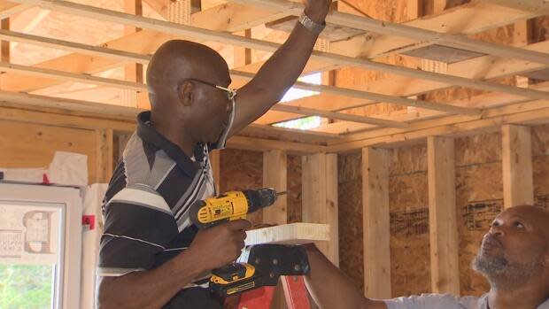 Apprentice Vincent Kennedy learns on the job from Howard Benjamin. They met through the East Preston Empowerment Academy.  (Brian MacKay/CBC - image credit)