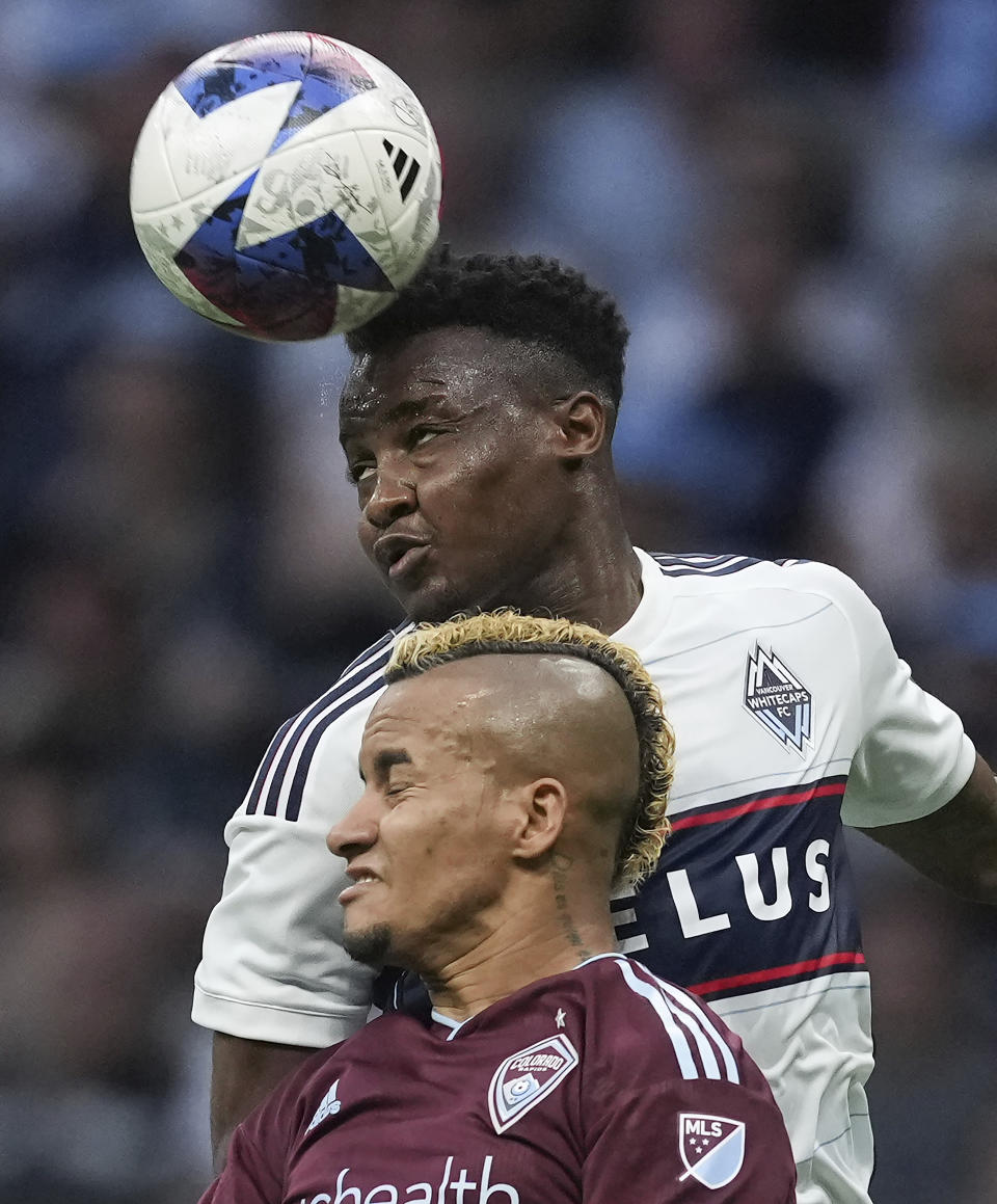 Vancouver Whitecaps' Javain Brown, back, and Colorado Rapids' Michael Barrios vie for the ball during the first half of an MLS soccer match Saturday, April 29, 2023, in Vancouver, British Columbia. (Darryl Dyck/The Canadian Press via AP)