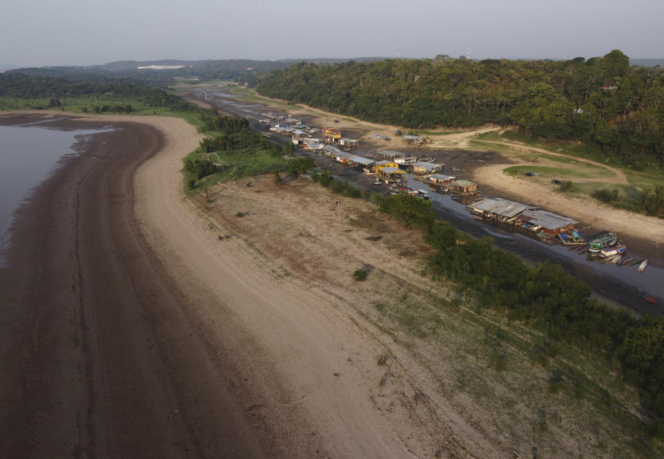 FILE - Floating homes and boats lay stranded on the dry bed of Puraquequara lake, amid a severe drought, in Manaus, Amazonas state, Brazil, Oct. 5, 2023. Human-induced global warming was the primary driver of last year's severe drought in the Amazon that sent rivers to record lows, researchers said Wednesday, Jan. 24, 2024. (AP Photo/Edmar Barros, File)