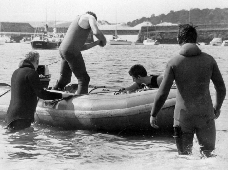 Police frogmen search the area where Lord Mountbatten was killed when an IRA bomb destroyed his boat off the coast of Co Sligo (PA) (PA Archive)