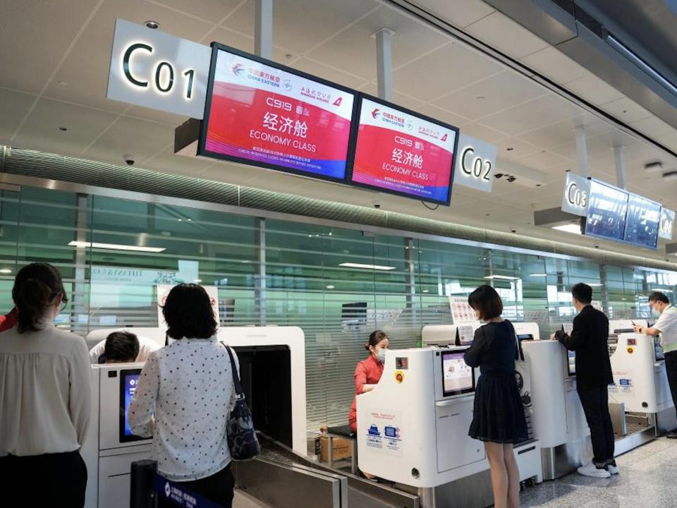 Passengers check in to first COMAC C919 flight.