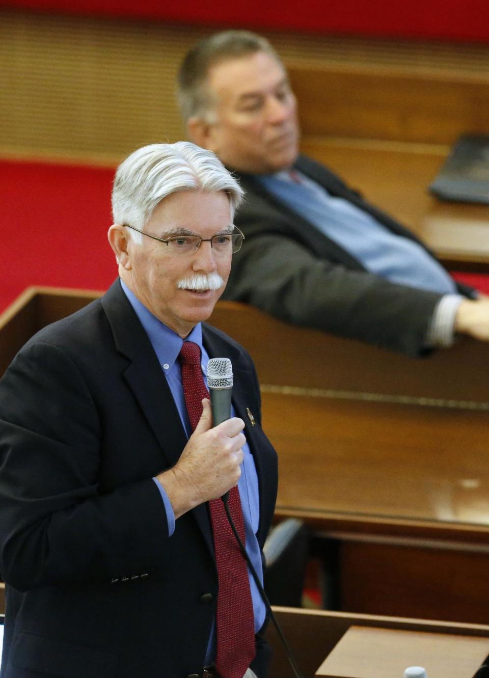 Rep. Jeff Collins, a Republican from Rocky Mount, protests the North Carolina General Assembly's fifth special session as unconstitutional Wednesday, Dec. 21, 2016, in the House chambers, in Raleigh, N.C. North Carolina's legislature reconvened Wednesday to decide whether enough lawmakers are willing to repeal a 9-month-old law that limited LGBT rights, including which bathrooms transgender people can use in public schools and government buildings. (Chris Seward/The News & Observer via AP)